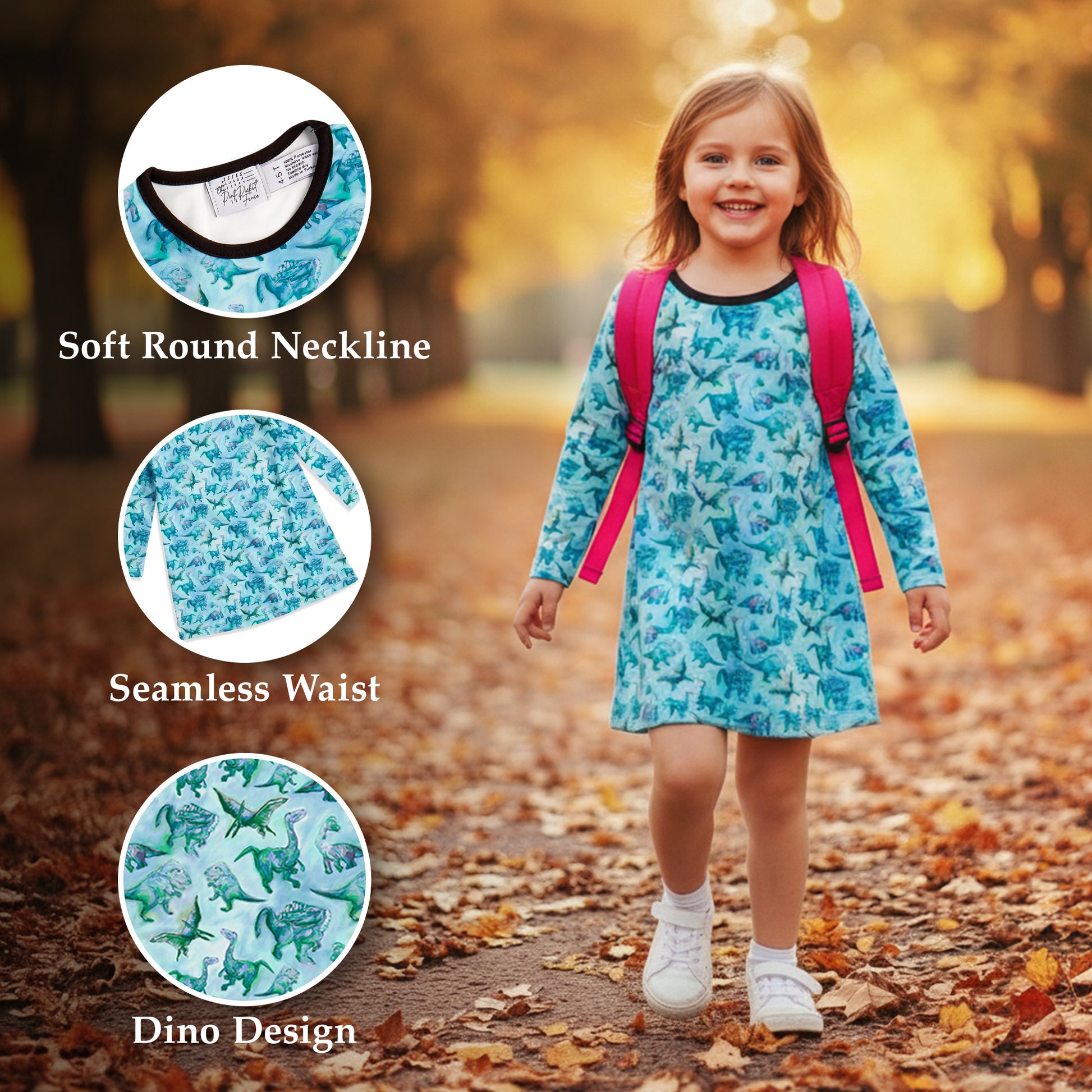 Child wearing a blue dinosaur-patterned dress with pink straps, standing outdoors on a leafy path.