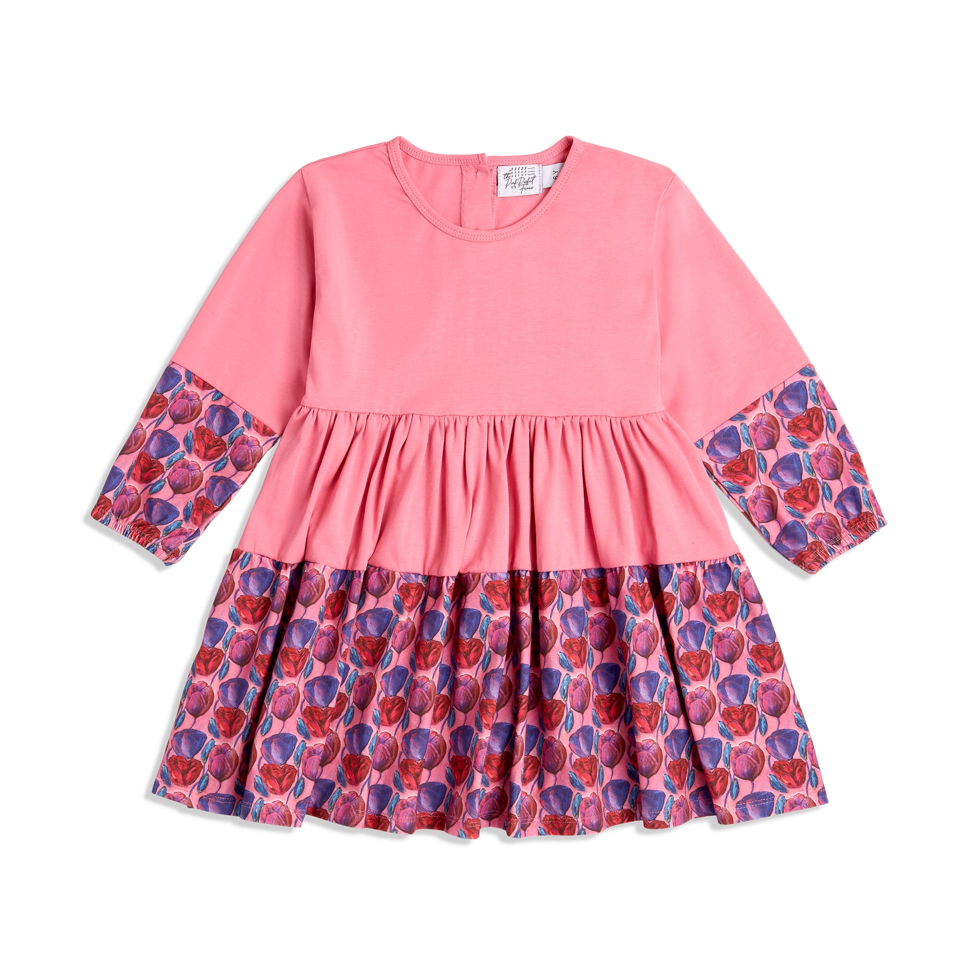 Flat lay of pink long sleeve twirl dress for toddler girls; organic cotton dress by The Pink Picket Fence