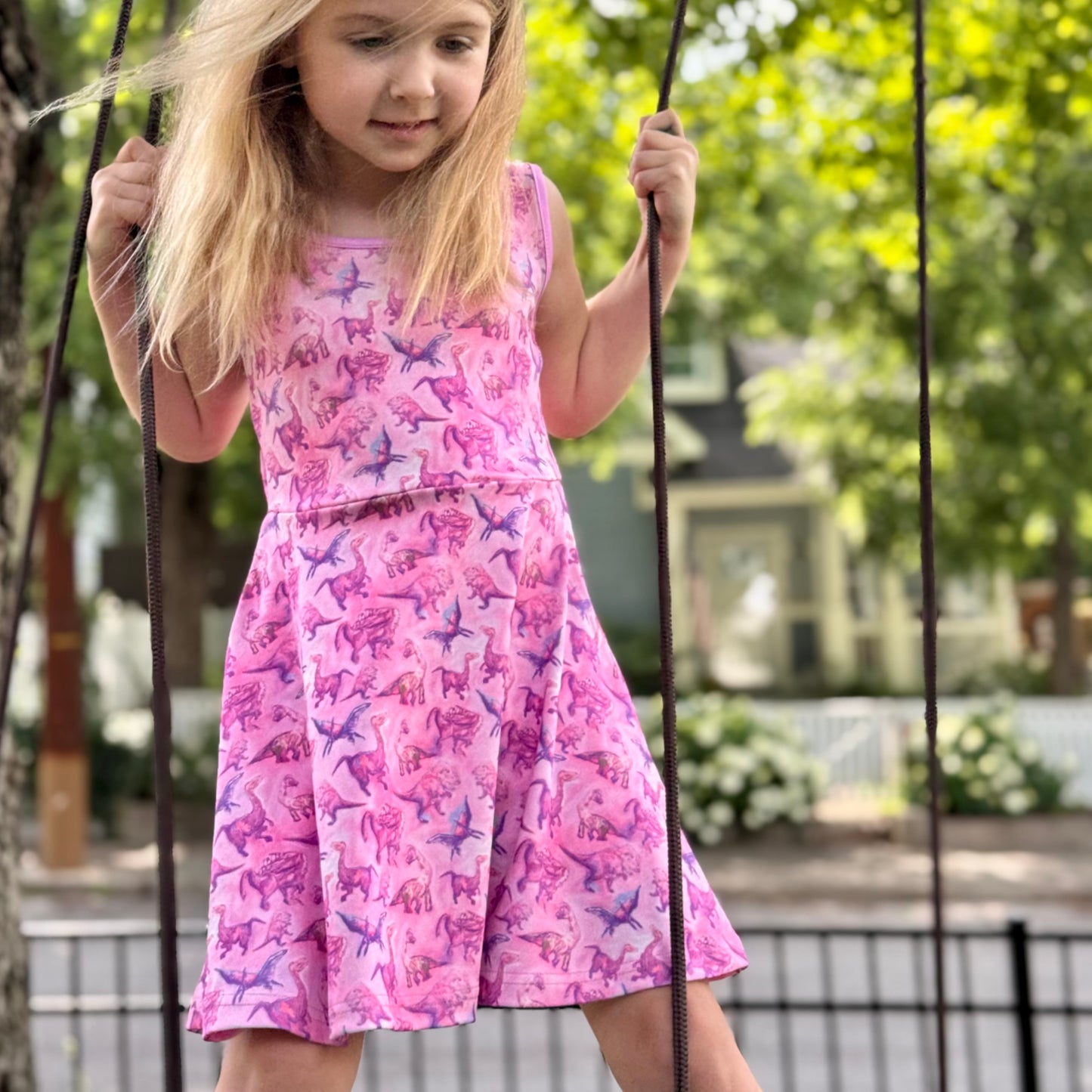 Sleeveless girls pink dinosaur dress for toddlers with colorful prehistoric print – soft sensory-friendly fabric for summer play