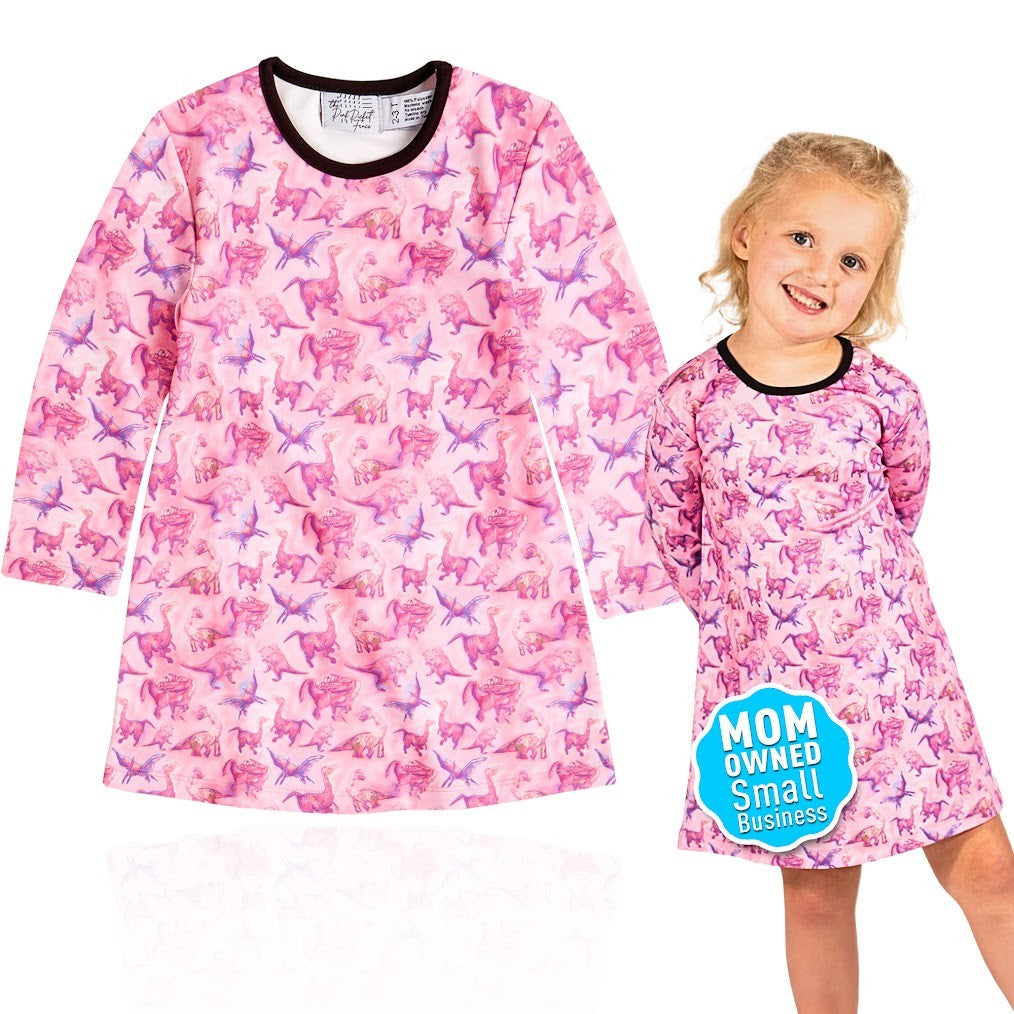 Pink dress with horse pattern worn by a child on a white background