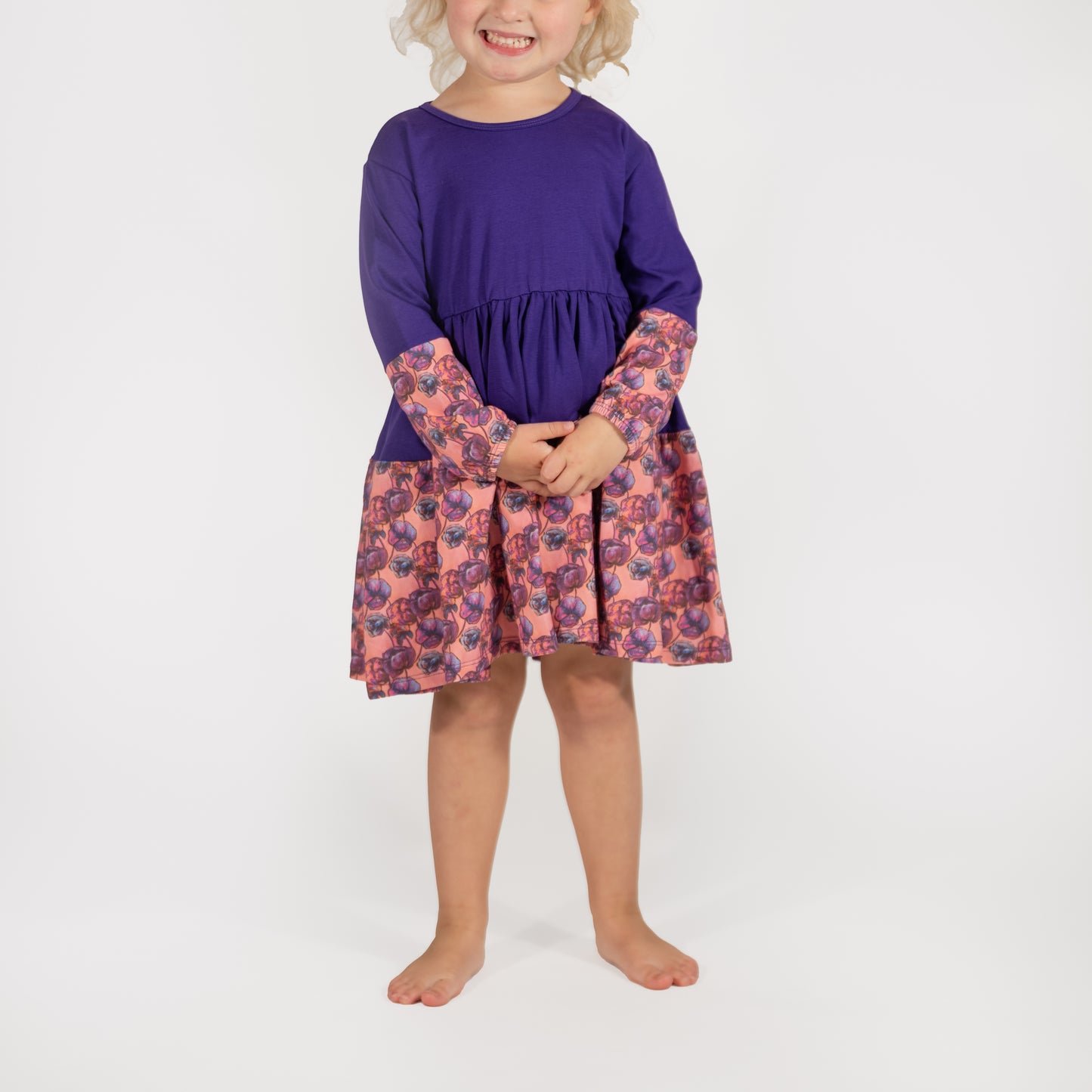 100% Cotton Dress- Child wearing the Purple Louise Twirl Dress with floral accents, designed for play and movement.