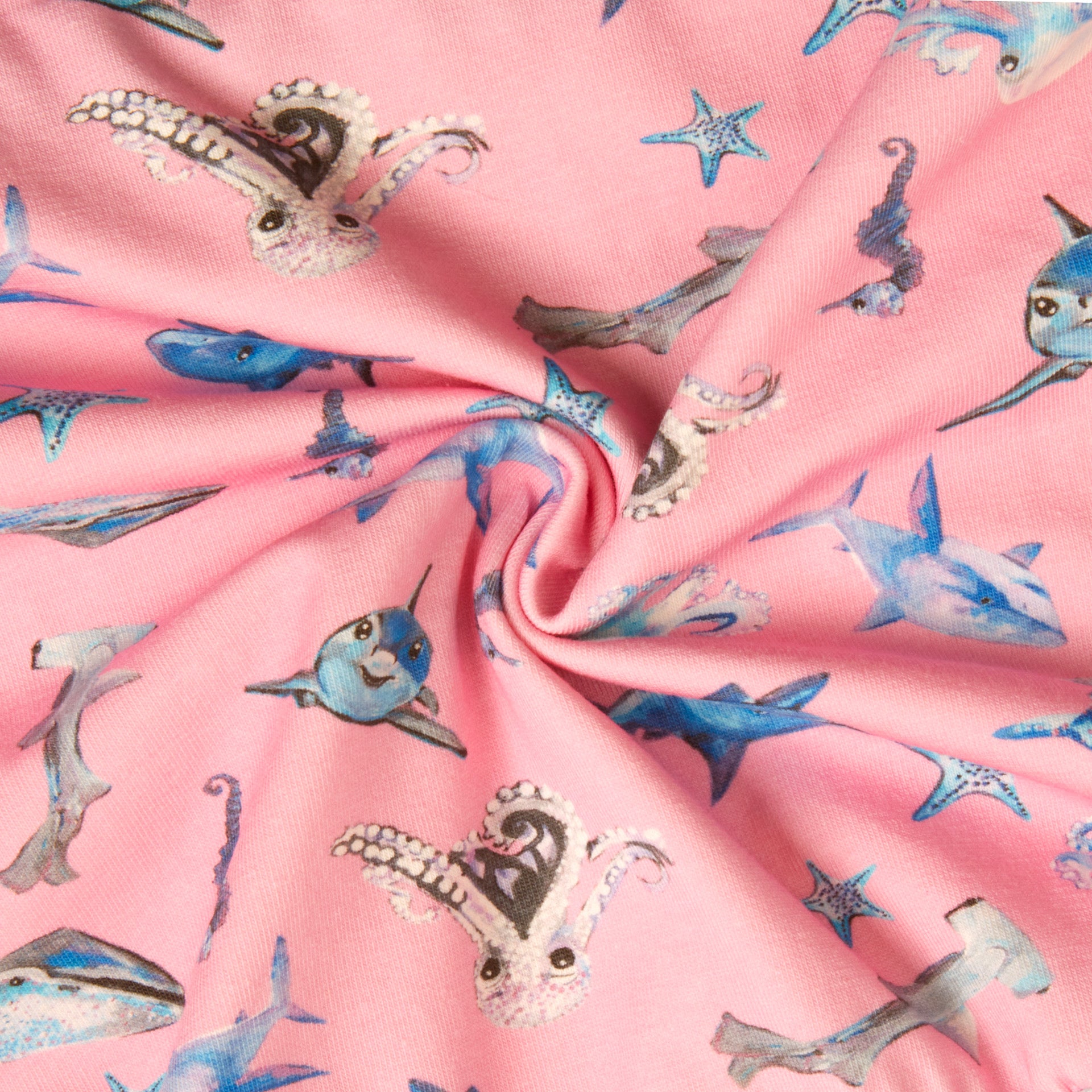 Close-up of pink underwater fabric pattern with octopuses, sharks, whales, seahorses, and starfish – soft 100% cotton for girls dress