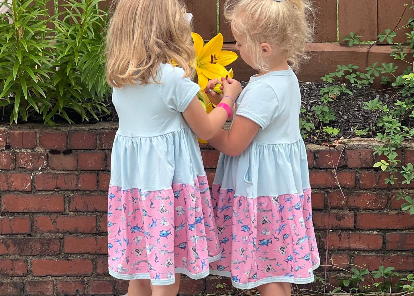 Two girls wearing shark print twirl dresses, soft cotton summer dresses for toddlers, sensory friendly kids clothing