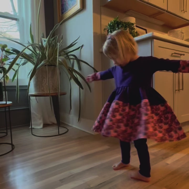 Best Twirly Dress - Little girl twirling in the Purple Louise Twirl Dress, featuring long sleeves and a full, spin-friendly skirt.