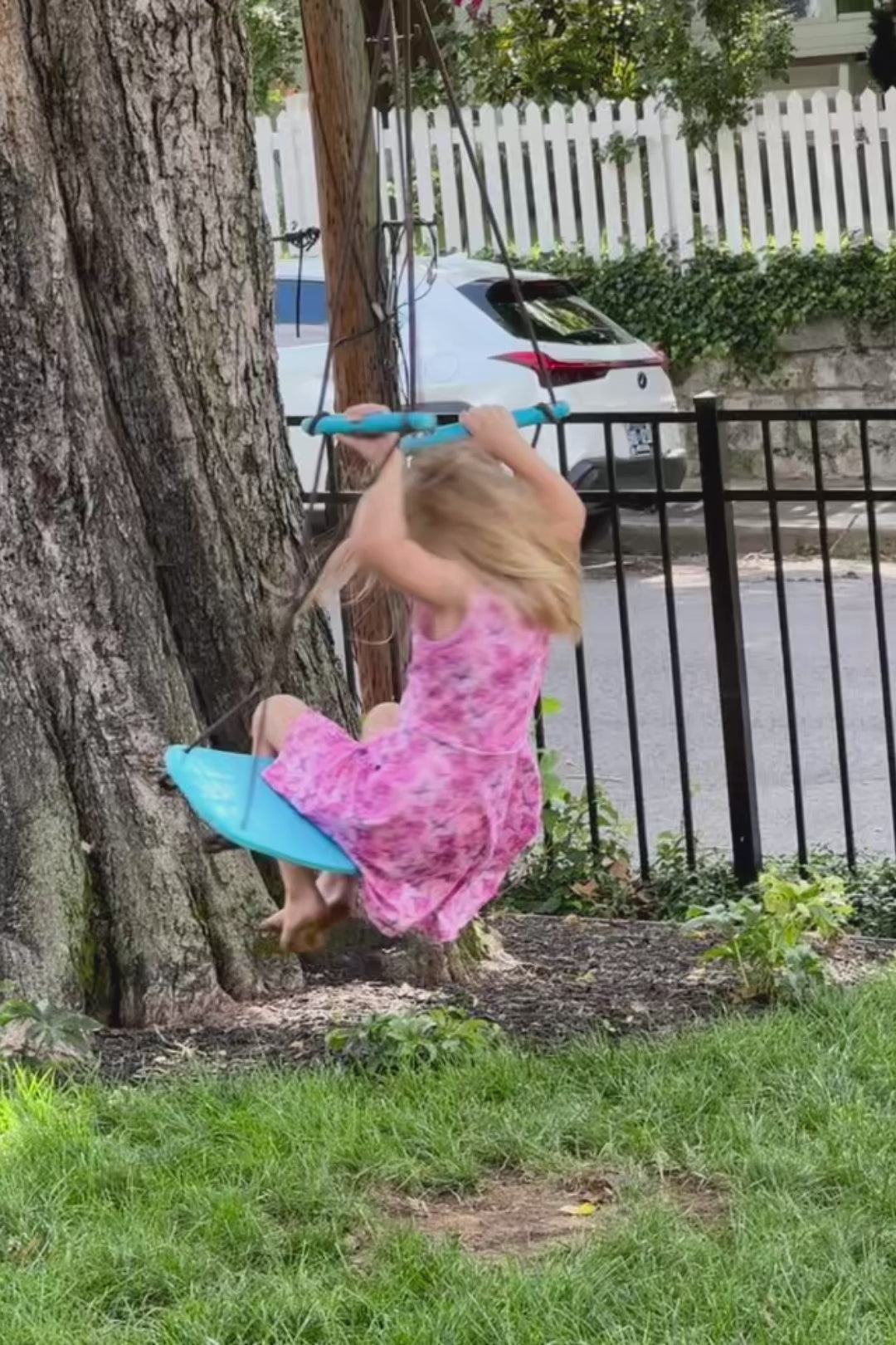 Video of toddler girl twirling and playing in pink dinosaur sleeveless dress – soft, sensory-friendly fabric for summer