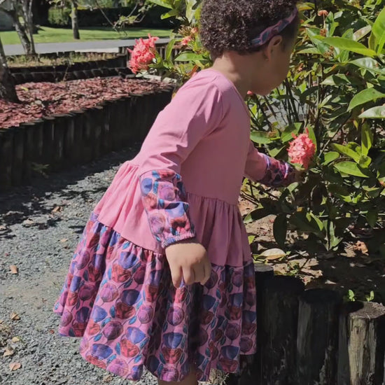 Little girl in a floral pink twirl dress; soft cotton dress for toddler and preschool girls