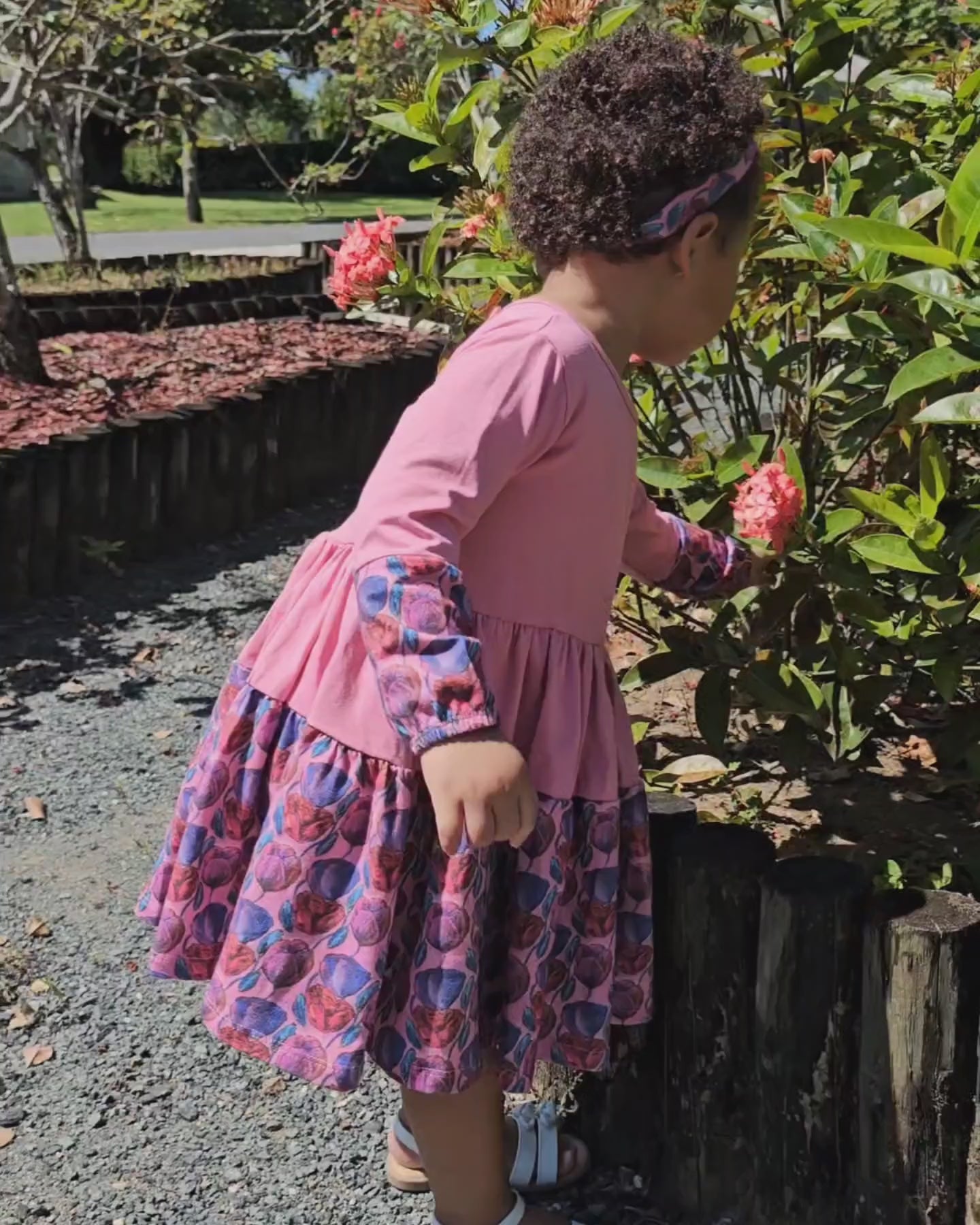 Little girl in a floral pink twirl dress; soft cotton dress for toddler and preschool girls